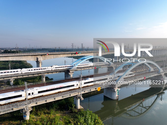 A bullet train runs on a railway bridge in Lianyungang, China, on October 9, 2024. (