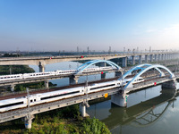 A bullet train runs on a railway bridge in Lianyungang, China, on October 9, 2024. (