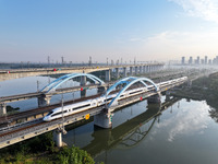 A bullet train runs on a railway bridge in Lianyungang, China, on October 9, 2024. (