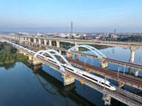 A bullet train runs on a railway bridge in Lianyungang, China, on October 9, 2024. (