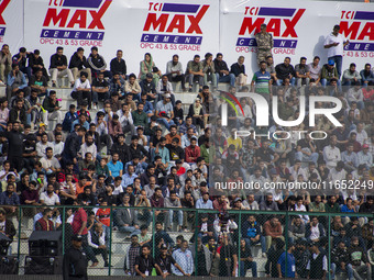 Spectators watch a cricket match during the Legends League Cricket match between Toyam Hyderabad and Southern Super Stars in Srinagar, Jammu...