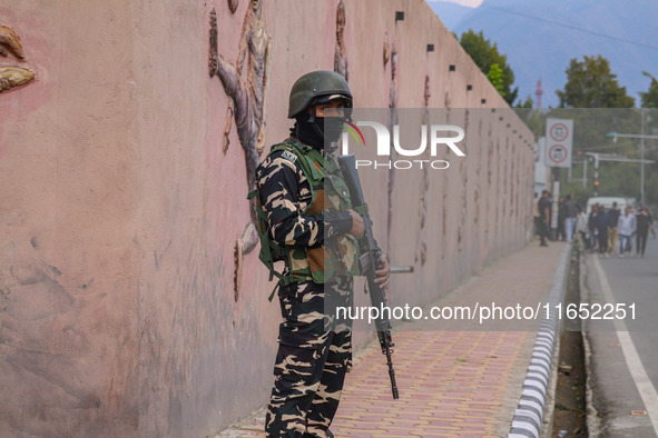 An Indian Paramilitary soldier stands guard during the Legends League Cricket match between Toyam Hyderabad and Southern Super Stars in Srin...