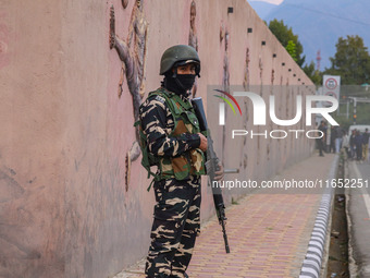 An Indian Paramilitary soldier stands guard during the Legends League Cricket match between Toyam Hyderabad and Southern Super Stars in Srin...