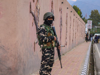 An Indian Paramilitary soldier stands guard during the Legends League Cricket match between Toyam Hyderabad and Southern Super Stars in Srin...