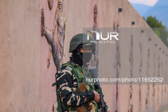 An Indian Paramilitary soldier stands guard during the Legends League Cricket match between Toyam Hyderabad and Southern Super Stars in Srin...