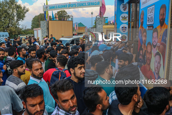 People wait in queue to enter Bakshi Stadium during the Legends League Cricket match between Toyam Hyderabad and Southern Super Stars in Sri...