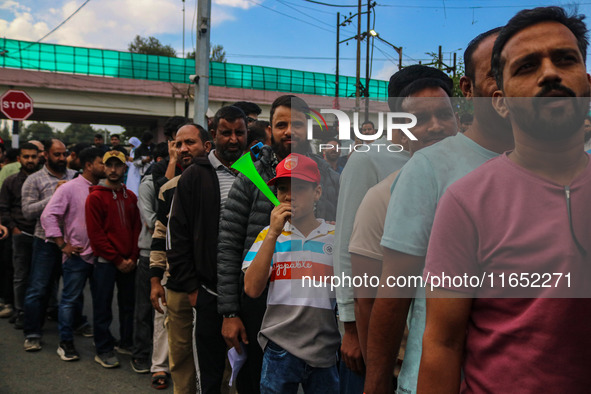 People wait in queue to enter Bakshi Stadium during the Legends League Cricket match between Toyam Hyderabad and Southern Super Stars in Sri...