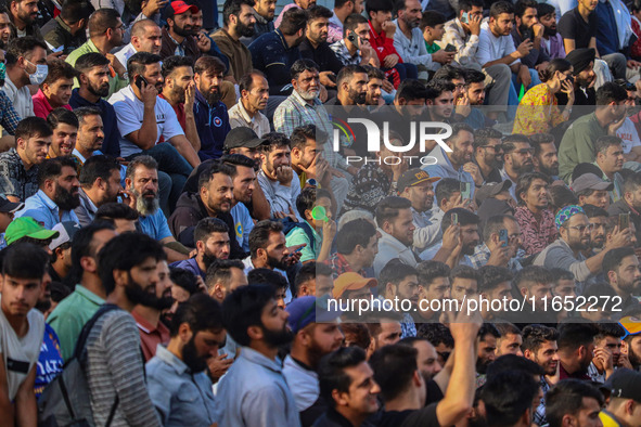 Spectators watch a cricket match during the Legends League Cricket match between Toyam Hyderabad and Southern Super Stars in Srinagar, Jammu...