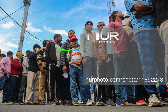 People wait in queue to enter Bakshi Stadium during the Legends League Cricket match between Toyam Hyderabad and Southern Super Stars in Sri...