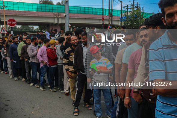 People wait in queue to enter Bakshi Stadium during the Legends League Cricket match between Toyam Hyderabad and Southern Super Stars in Sri...