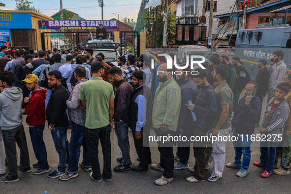 People wait in queue to enter Bakshi Stadium during the Legends League Cricket match between Toyam Hyderabad and Southern Super Stars in Sri...