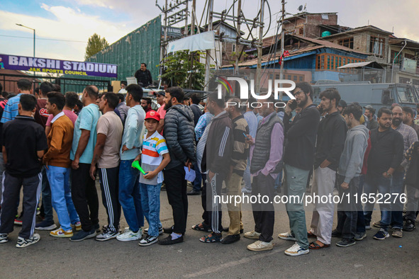 People wait in queue to enter Bakshi Stadium during the Legends League Cricket match between Toyam Hyderabad and Southern Super Stars in Sri...