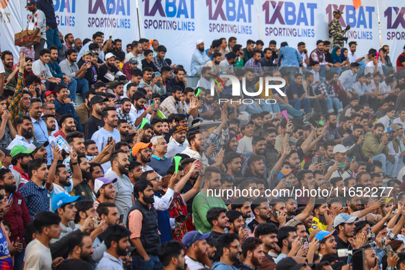 Spectators watch a cricket match during the Legends League Cricket match between Toyam Hyderabad and Southern Super Stars in Srinagar, Jammu...