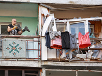 A man stands on the balcony of a residential building damaged by a Russian drone attack in Chornomorsk, Odesa region, southern Ukraine, on O...