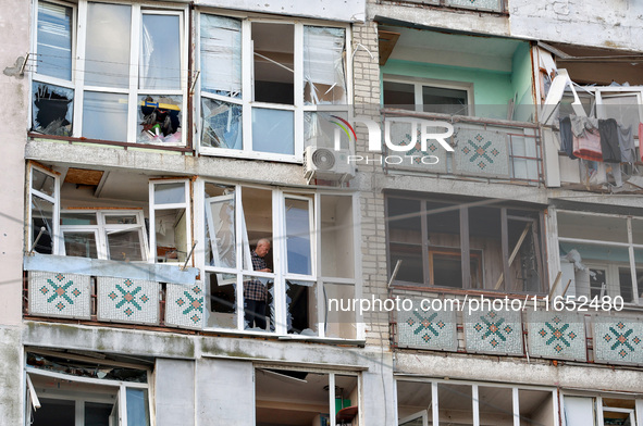 A man stands on the balcony of a residential building damaged by a Russian drone attack in Chornomorsk, Odesa region, southern Ukraine, on O...