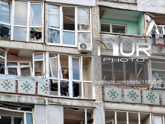 A man stands on the balcony of a residential building damaged by a Russian drone attack in Chornomorsk, Odesa region, southern Ukraine, on O...