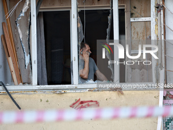 A man stands on the balcony of a residential building damaged by a Russian drone attack in Chornomorsk, Odesa region, southern Ukraine, on O...