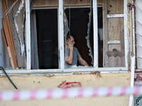 A man stands on the balcony of a residential building damaged by a Russian drone attack in Chornomorsk, Odesa region, southern Ukraine, on O...