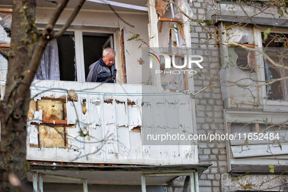 A man stands on the balcony of a residential building damaged by a Russian drone attack in Chornomorsk, Odesa region, southern Ukraine, on O...