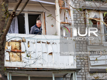 A man stands on the balcony of a residential building damaged by a Russian drone attack in Chornomorsk, Odesa region, southern Ukraine, on O...