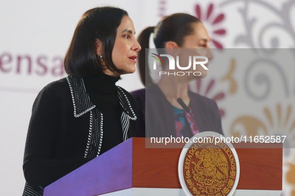 Mexico's President Claudia Sheinbaum Pardo stands behind while Luz Elena Gonzalez, Secretary of Energy, speaks during a briefing conference...