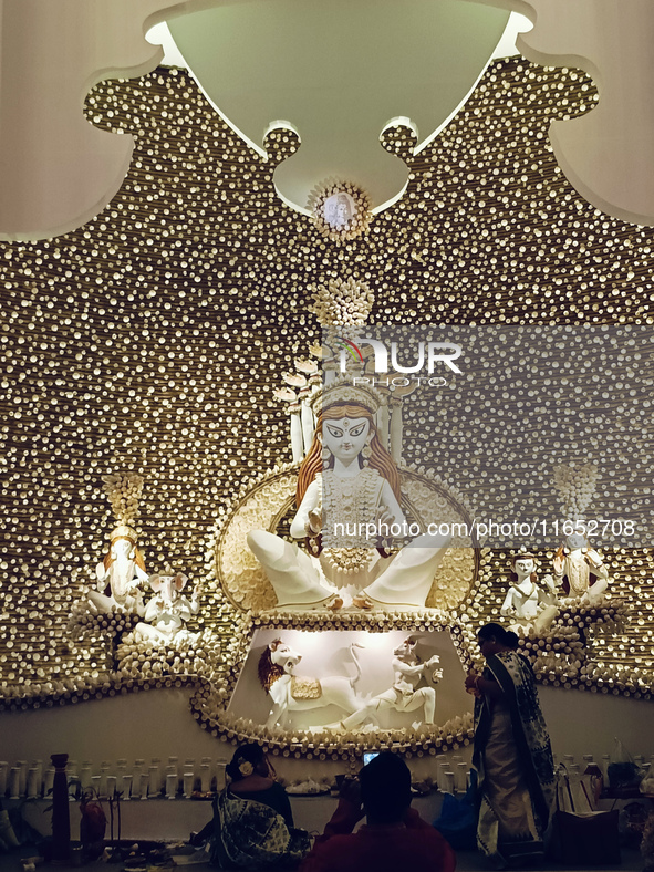 An idol of the Hindu goddess Durga is placed on an altar inside a pandal, marking Durga Puja festival celebrations in Kolkata, India, on Oct...