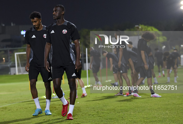 Al Moez Ali (R) and Ibrahim Al Hassan (L) from the Qatar National football team attend a training session at Aspire Academy in Doha, Qatar,...