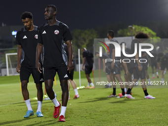 Al Moez Ali (R) and Ibrahim Al Hassan (L) from the Qatar National football team attend a training session at Aspire Academy in Doha, Qatar,...