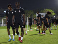 Al Moez Ali (R) and Ibrahim Al Hassan (L) from the Qatar National football team attend a training session at Aspire Academy in Doha, Qatar,...