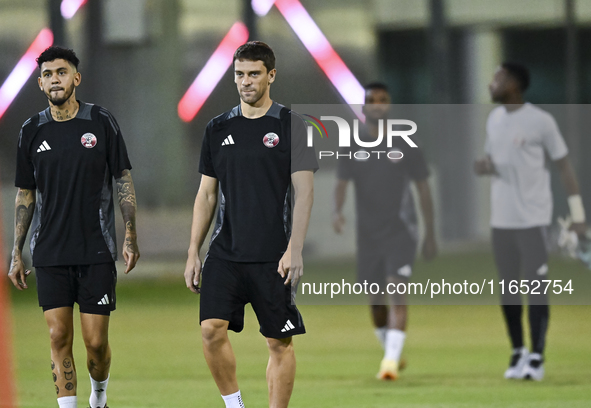 Lucas Mendez (R) and Edmilson Junior (L) from the Qatar National football team attend a training session at Aspire Academy in Doha, Qatar, o...