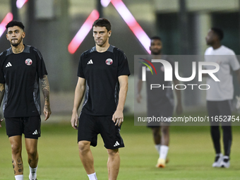 Lucas Mendez (R) and Edmilson Junior (L) from the Qatar National football team attend a training session at Aspire Academy in Doha, Qatar, o...