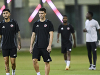 Lucas Mendez (R) and Edmilson Junior (L) from the Qatar National football team attend a training session at Aspire Academy in Doha, Qatar, o...