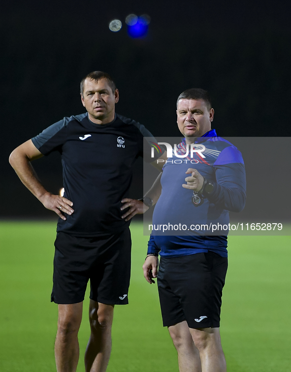 Head coach Maksim Lisitsyn (R) of the Kyrgyzstan National Team attends a training session at Qatar University training pitch in Doha, Qatar,...