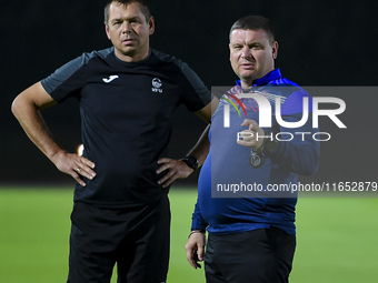 Head coach Maksim Lisitsyn (R) of the Kyrgyzstan National Team attends a training session at Qatar University training pitch in Doha, Qatar,...