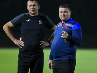 Head coach Maksim Lisitsyn (R) of the Kyrgyzstan National Team attends a training session at Qatar University training pitch in Doha, Qatar,...