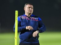 Head coach Maksim Lisitsyn (R) of the Kyrgyzstan National Team attends a training session at Qatar University training pitch in Doha, Qatar,...