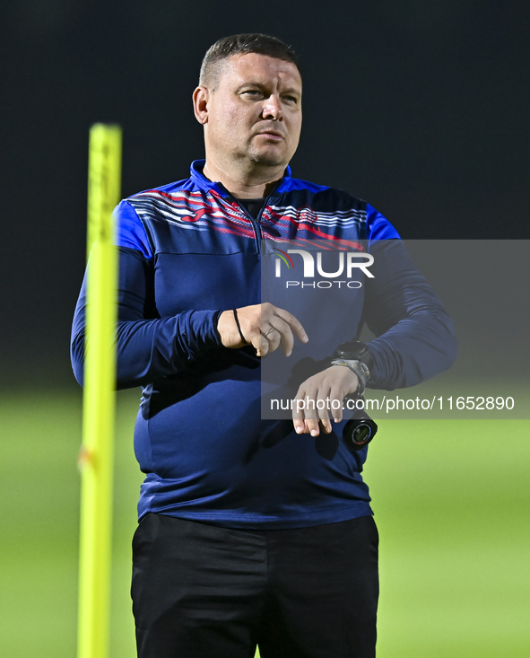 Head coach Maksim Lisitsyn (R) of the Kyrgyzstan National Team attends a training session at Qatar University training pitch in Doha, Qatar,...