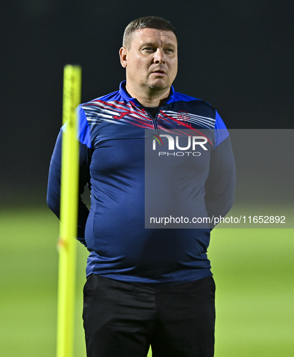 Head coach Maksim Lisitsyn (R) of the Kyrgyzstan National Team attends a training session at Qatar University training pitch in Doha, Qatar,...