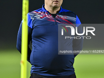 Head coach Maksim Lisitsyn (R) of the Kyrgyzstan National Team attends a training session at Qatar University training pitch in Doha, Qatar,...