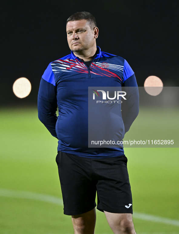 Head coach Maksim Lisitsyn (R) of the Kyrgyzstan National Team attends a training session at Qatar University training pitch in Doha, Qatar,...