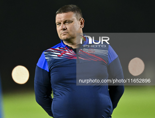 Head coach Maksim Lisitsyn (R) of the Kyrgyzstan National Team attends a training session at Qatar University training pitch in Doha, Qatar,...