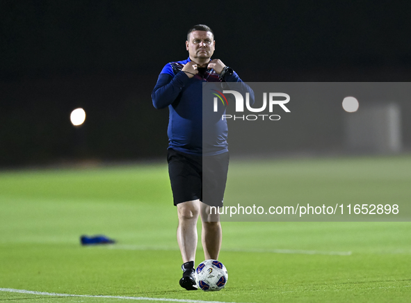 Head coach Maksim Lisitsyn (R) of the Kyrgyzstan National Team attends a training session at Qatar University training pitch in Doha, Qatar,...