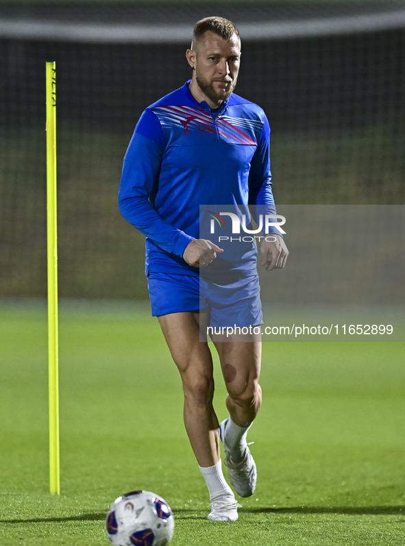 Kyrgyzstan team player Kichin Valerii participates in the training session at Qatar University training pitch in Doha, Qatar, on October 9,...