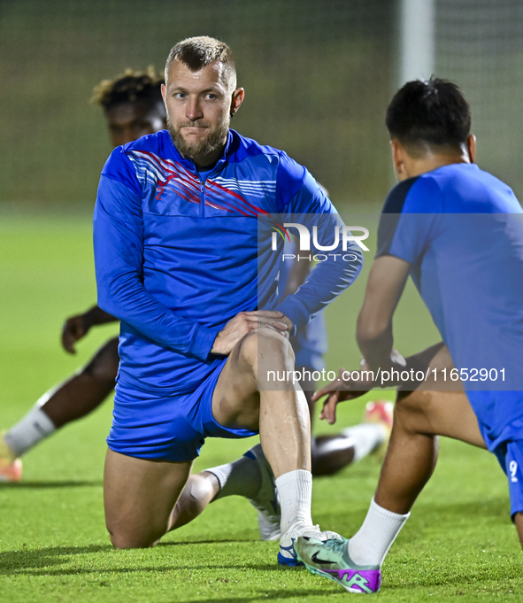 Kyrgyzstan team player Kichin Valerii participates in the training session at Qatar University training pitch in Doha, Qatar, on October 9,...