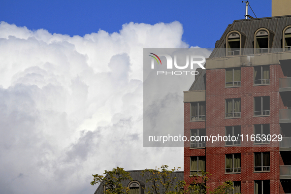 A large rain cloud passes by an apartment building in downtown Brampton, Ontario, Canada, on October 9, 2024. 