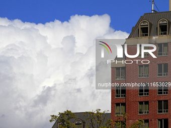 A large rain cloud passes by an apartment building in downtown Brampton, Ontario, Canada, on October 9, 2024. (