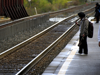 A commuter looks at his phone while waiting for a train at the Innovation District station in downtown Brampton, Ontario, Canada, on October...