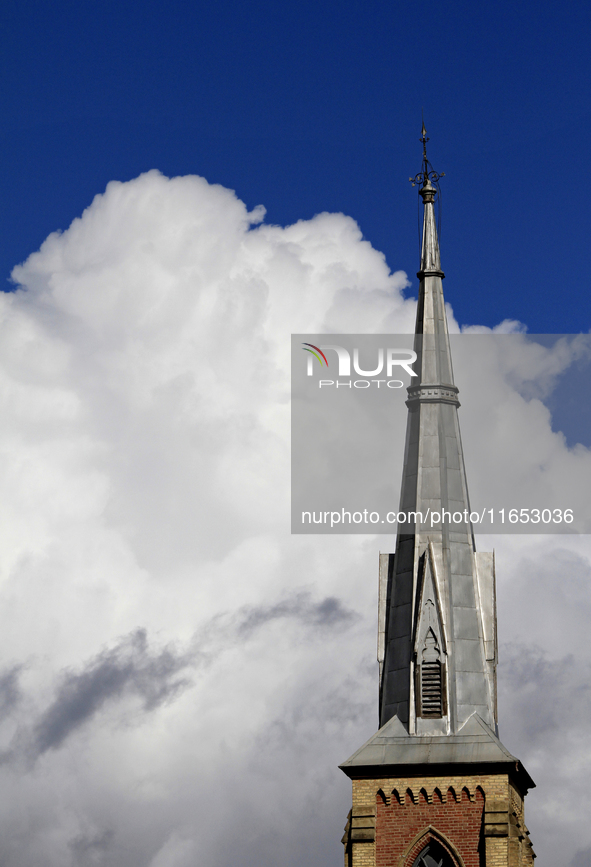 A large rain cloud passes by the spire of Grace United Church on Main Street in downtown Brampton, Ontario, Canada, on October 9, 2024. 