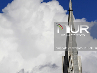 A large rain cloud passes by the spire of Grace United Church on Main Street in downtown Brampton, Ontario, Canada, on October 9, 2024. (