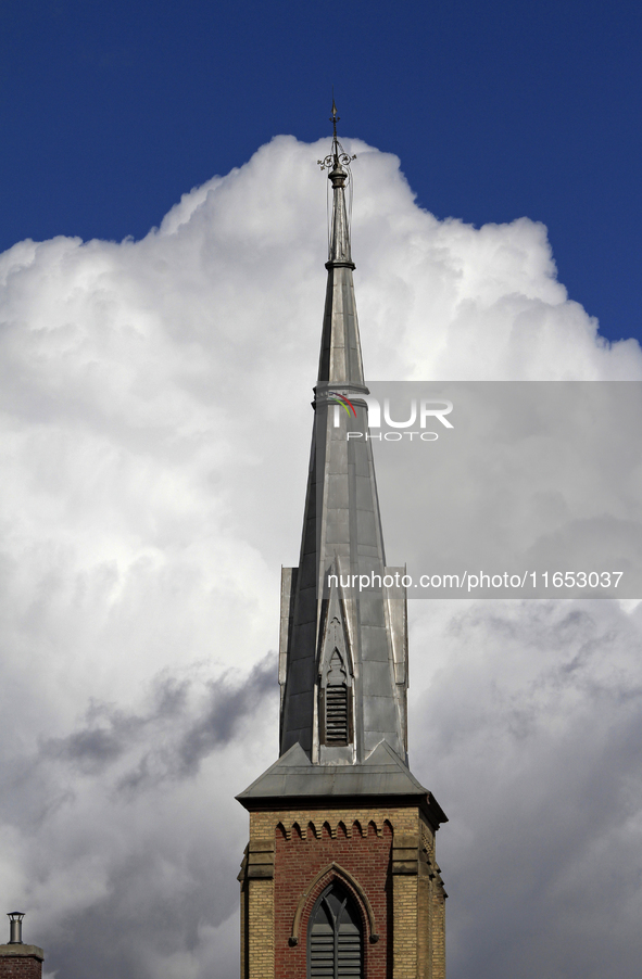 A large rain cloud passes by the spire of Grace United Church on Main Street in downtown Brampton, Ontario, Canada, on October 9, 2024. 